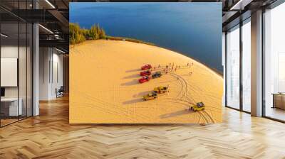 Aerial view of Bau Trang lake (raw of automobiles with blue sky in desert, beautiful landscape of white sand dunes), the popular tourist attraction place in Mui Ne, Vietnam. Wall mural