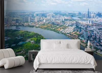 Panoramic view of Saigon, Vietnam from above at Ho Chi Minh City's central business district. Cityscape with Landmark 81 skyscraper and many buildings, local houses, rivers. Landscape concept. Wall mural