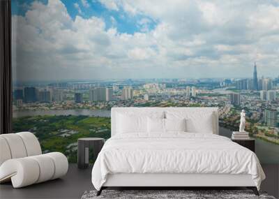 Panoramic view of Saigon, Vietnam from above at Ho Chi Minh City's central business district. Cityscape with Landmark 81 skyscraper and many buildings, local houses, rivers. Wall mural