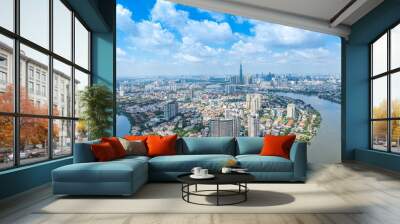 Panoramic view of Saigon, Vietnam from above at Ho Chi Minh City's central business district. Cityscape with Landmark 81 skyscraper and many buildings, local houses, rivers. Wall mural