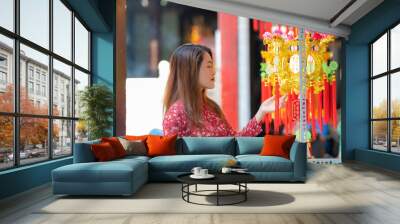 Vietnamese girl with Ao Dai dress and decorated colorful lanterns hanging on a stand in the streets in Ho Chi Minh City, Vietnam during Mid Autumn Festival. Wall mural