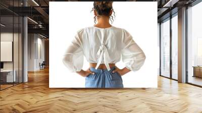 Back view mid body shot of a 25 year old beautiful Latin woman wearing a white blouse and blue culottes isolated on a white transparent background Wall mural