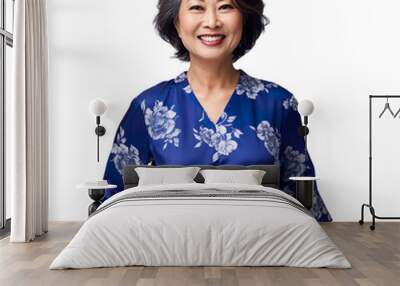 Front view mid shot of a 60-year-old refined Asian woman dressed in a royal blue midi dress with a floral print, smiling on a white transparent background Wall mural