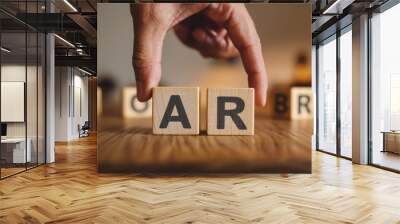 A hand is holding up two wooden blocks that spell out the word AR Wall mural