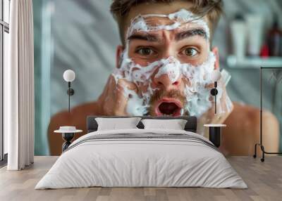 A man is washing his face with foam and has a surprised expression on his face Wall mural