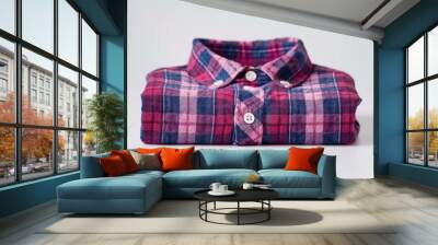 A stylish folded plaid shirt on a clean white backdrop emphasizes casual chic for any laidback occasion. Wall mural