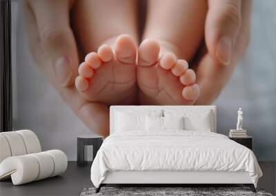 A tender moment captured, showcasing baby feet cradled in loving adult hands, symbolizing care and affection. Wall mural