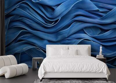 Neatly stacked blue jeans showcase a stylish denim backdrop, perfect for a trendy clothing display. Wall mural