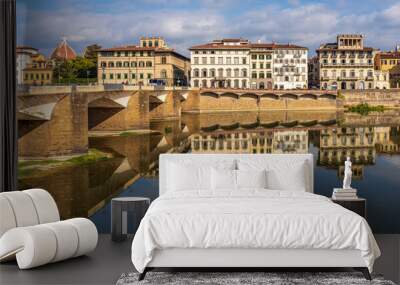 Reflections in the river of beautiful old buildings in Florence Italy Wall mural