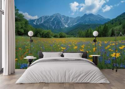 Beautiful landscape A magnificent forest glade of flowers with stunning mountains in the background Wall mural