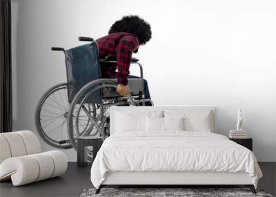 Afro man walking with a wheelchair on studio Wall mural