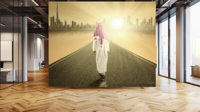 Arabic person walks on the road Wall mural