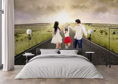 Attractive family playing on the road Wall mural