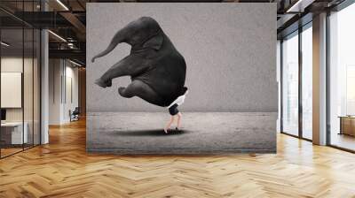 businesswoman lifting heavy elephant Wall mural