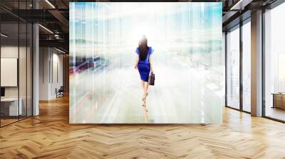 businesswoman walking toward bright light Wall mural