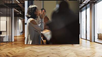 Christian Asian woman prays in the church Wall mural