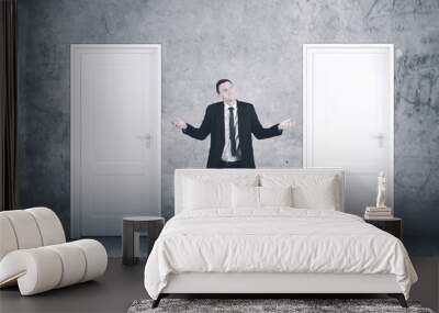 confused caucasian businessman with two choices Wall mural