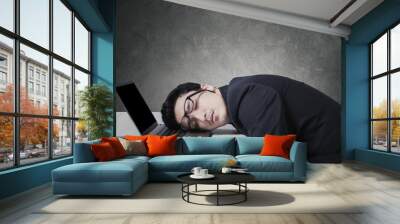 Exhausted businessman sleeping on his laptop Wall mural