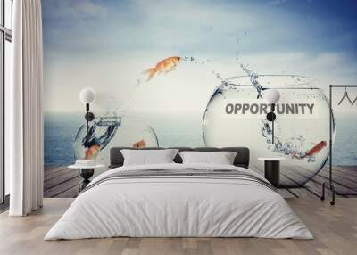 Goldfish jumping out to aquarium with opportunity text Wall mural