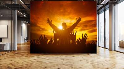 International human rights day concept: Human raised hands for worship God over amazing light of sunset background Wall mural