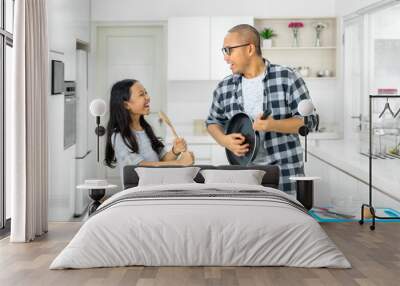 Little girl and father singing together in kitchen Wall mural