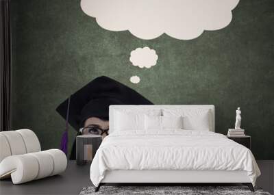 Pensive graduate with blank board and cloud Wall mural