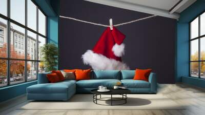 Santa hat hanging isolated on grey Wall mural