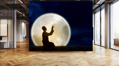 silhouette muslim man praying with a huge full moonlight background Wall mural