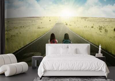 Two students walking with sunrise on the road Wall mural