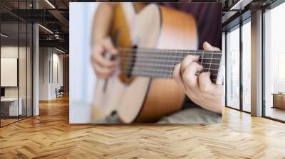 Unknown little boy is strumming acoustic guitar Wall mural