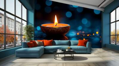 A single candle is lit, casting warm light on the dark background with blurred lights in the distance, Diwali celebration Wall mural