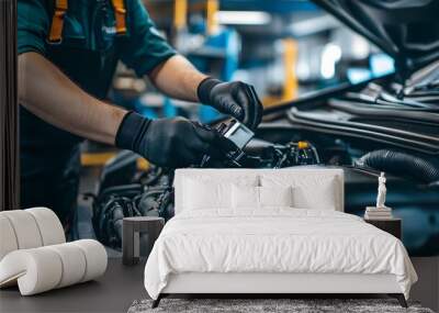 Mechanic working on car engine in auto repair shop Wall mural