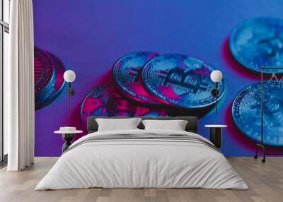 Bitcoin coins under neon light. The currency of the future. Wall mural