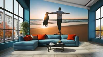 Life is good. Man with open arms enjoying life and freedom on the beach with sunset Wall mural