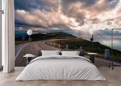 Mountain road at sunset. Empty asphalt road through the mountains of Serra Da Estrela natural park, Northern Portugal Wall mural