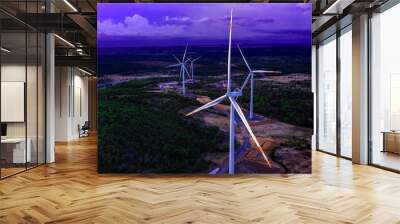 Wind turbines or wind power generators at sunset in the evening. Alternative green ecological power energy generation Wall mural