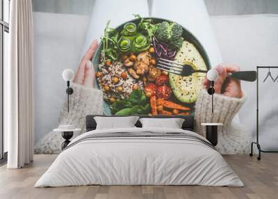 Woman holding plate with tasty vegan or vegetarian food. Healthy vegan meal. Vegan buddha bowl with healthy food. Healthy eating or diet Wall mural