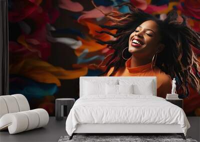 A stylish young Black woman celebrating and having fun with a hair flip, dancing, and smiling in a vibrant studio setting. Wall mural