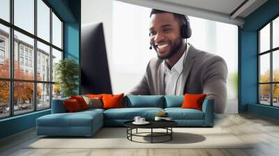 Humble happy call center person talking on headphones while looking at a computer Wall mural