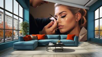 Makeup artist applying makeup and eyeshadow to a model Wall mural