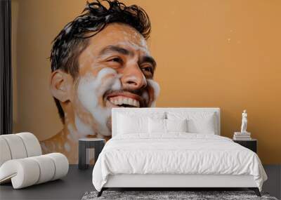 smiling man putting on face mask and shaving his face Wall mural