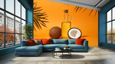 Coconut and coconut oil in a glass bottle with fresh coconut fruit on orange background Wall mural