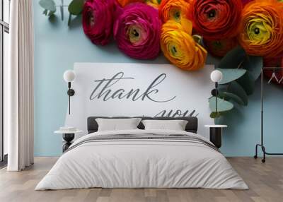 Flowers and thank you note with vibrant ranunculus blossoms on a blue background Wall mural