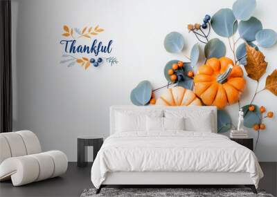 Pumpkins in thankful decoration with autumn leaves and blue berries for seasonal celebration Wall mural