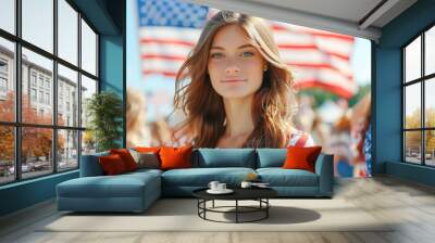 Young woman celebrating patriotism with American flags in the background during festive summer event Wall mural