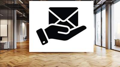 Hand holding an envelope symbolizing email delivery or message service icon Wall mural