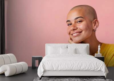 Young bald Hispanic woman with hand on chin, breast cancer awareness
 Wall mural