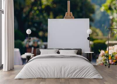 A blank canvas stands on an easel as part of an elegant event setup Wall mural