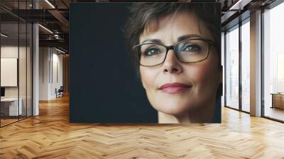 Portrait of an attractive middle aged woman wearing glasses and sporting short hair Wall mural