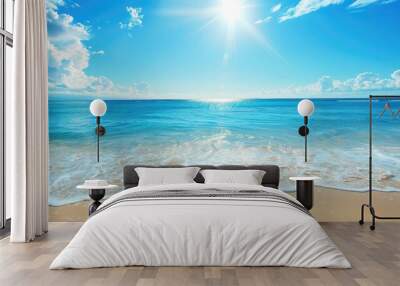 Serene beach with clear blue water and sunny sky Wall mural